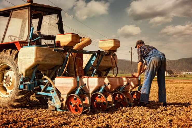 farmer-preparing-his-tractor-with-maize-seeds_69477-45